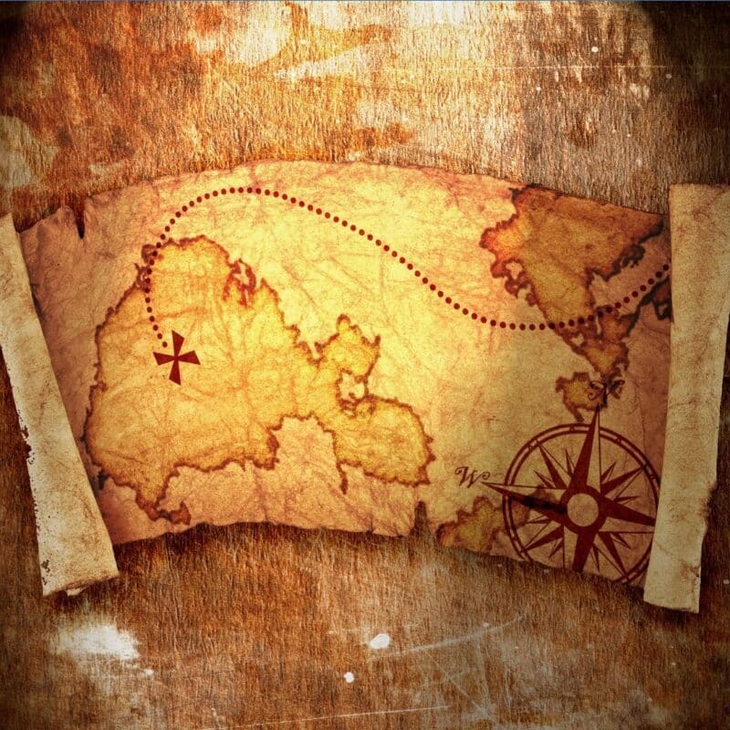 Aged treasure map with a red dotted path and compass rose