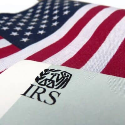 IRS document partially covering an American flag