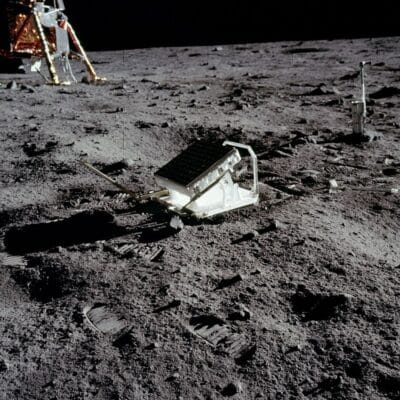 Lunar surface with a deployed retroreflector array and a nearby lander leg