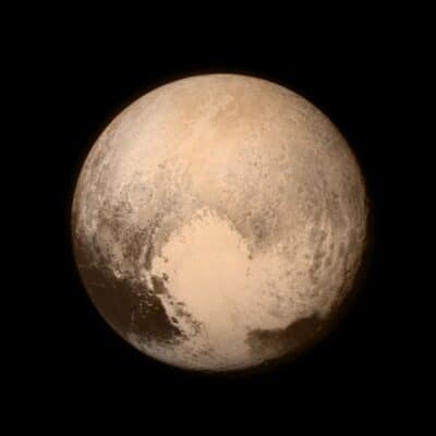 Pluto, showing its brown and beige surface against a black background