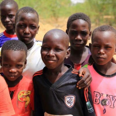 Group of young boys smiling outdoors in Niger
