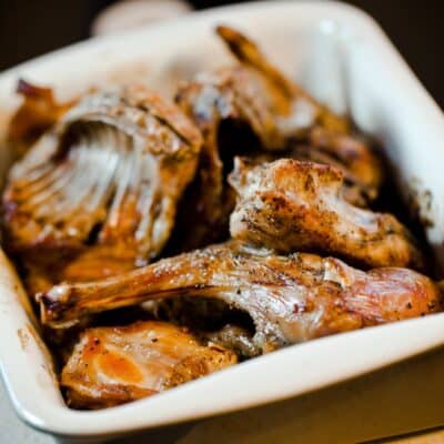 Cooked rabbit meat in a white dish