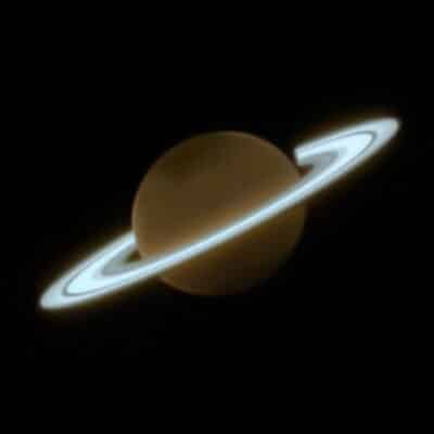 Brown Saturn with bright bluish rings encircling it against black space