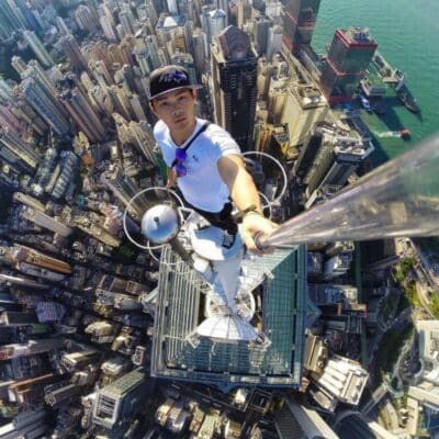 Person taking a selfie on the edge of a tall skyscraper