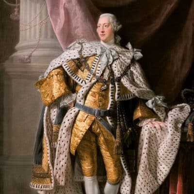King George III wearing a gold outfit with a royal ermine-trimmed robe