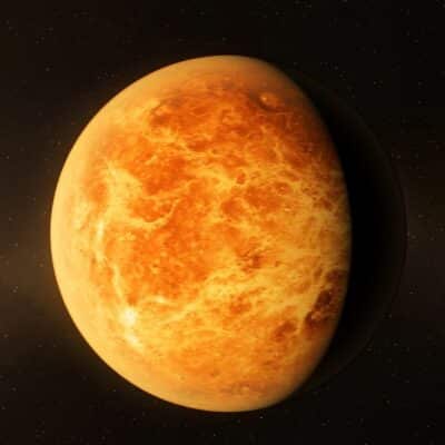 A detailed view of the planet Venus with a dark shadow cast along its edge