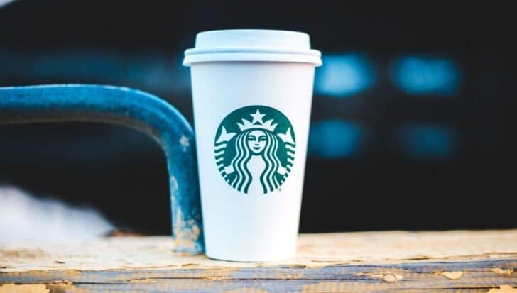 Starbucks cup positioned on a surface with a blurred background