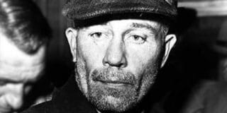 Ed Gein wearing a cap, being arrested