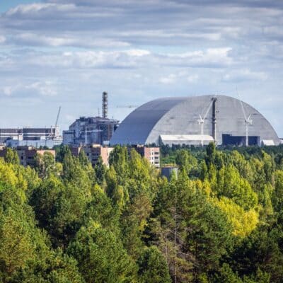 Chernobyl Nuclear Power Plant with protective sarcophagus and surrounding forest