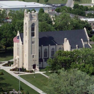 Stone chapel with American flag on College of the Ozarks campus