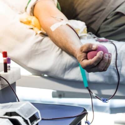 Person donating blood while squeezing a stress ball