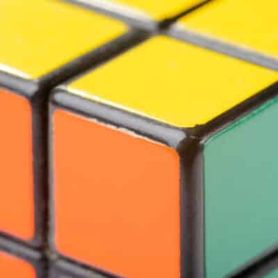 Close-up of a Rubik's Cube showing yellow, orange, and green squares