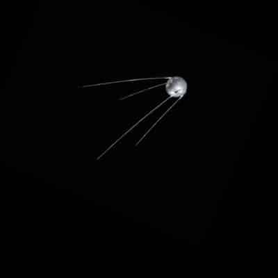 Sputnik 1 satellite with four long antennas against a black background