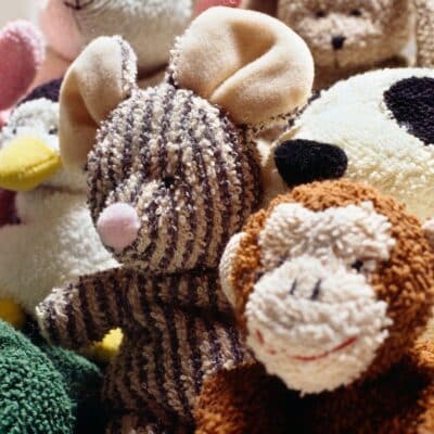 Assorted stuffed animals including a mouse, monkey, penguin, panda, and bear