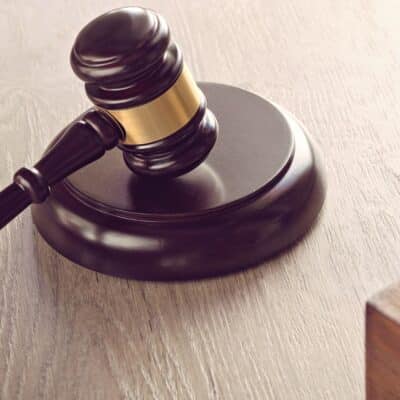 Close-up of a judge's gavel resting on a wooden surface