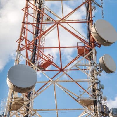 Close-up of a telecommunications tower with satellite dishes and antennas