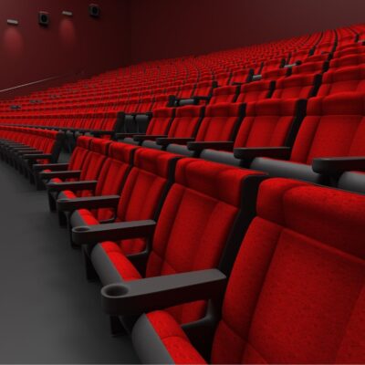 Empty red theater seats in a modern cinema auditorium