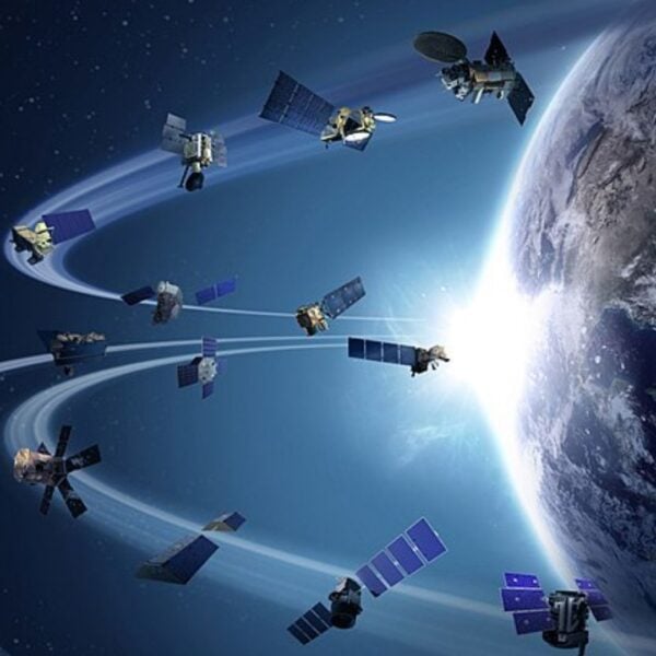 Multiple spacecraft orbiting Earth with sunlight in the background