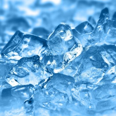 Close-up of translucent ice cubes with a blue tint