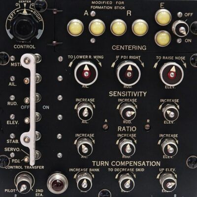 Close-up of vintage aircraft autopilot control panel with labeled switches and dials