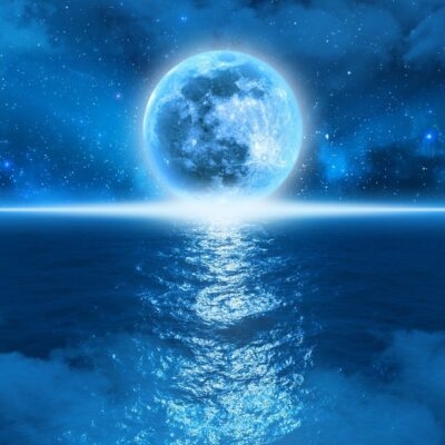 Bright blue moon reflecting over a calm ocean under a starry night sky