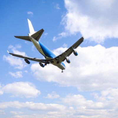 Boeing 747 flying against a backdrop of clouds and blue sky