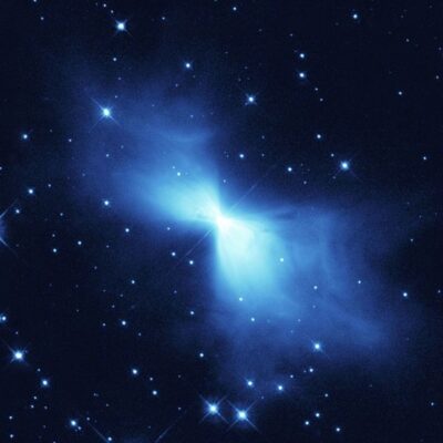 Boomerang Nebula glowing blue amid surrounding stars in deep space