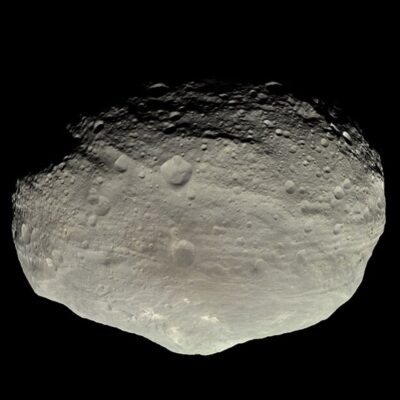 Cratered surface of asteroid 4 Vesta against black space background