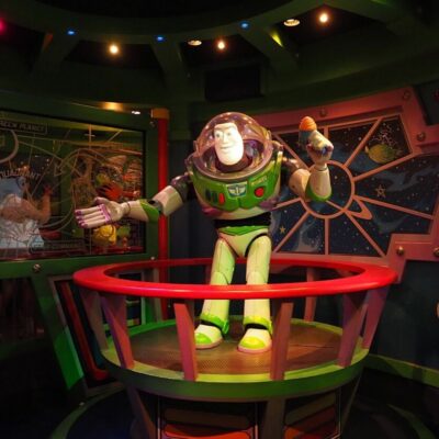 Buzz Lightyear figure in a colorful sci-fi themed room with space graphics