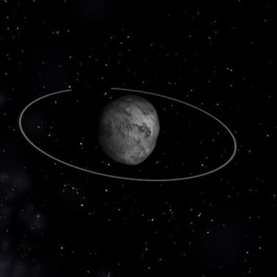 Chariklo asteroid with visible ring system against a star-filled background