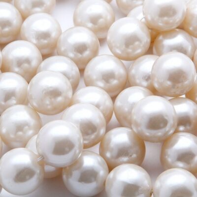 Close-up of multiple white, round pearls with a glossy surface