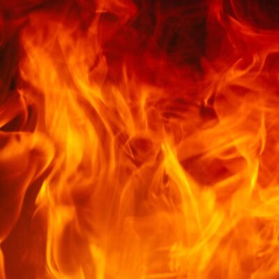Bright orange and yellow flames rising against a dark background