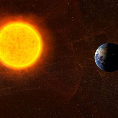 The Sun glowing brightly near the rotating Earth in space