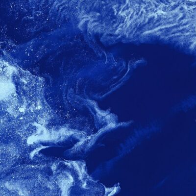 Swirling blue and white patterns resembling interstellar clouds or cosmic dust