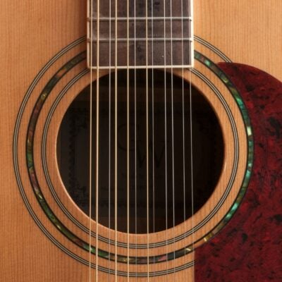 Close-up of a 12-string acoustic guitar soundhole and strings