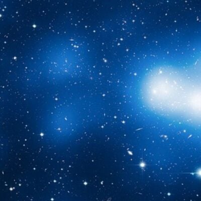 Bright galaxies and stars scattered across deep space with glowing clusters