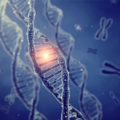 Close-up of DNA double helix with glowing section and chromosomes in background