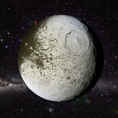 Saturn's moon Iapetus showing distinct light and dark hemispheres against starry background