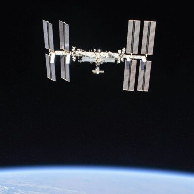 International Space Station orbiting above Earth with large solar arrays extended