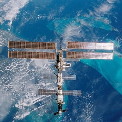 International Space Station orbiting above Earth with solar panels extended