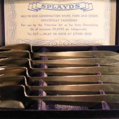 Set of six metal splayds in a display case with informational card