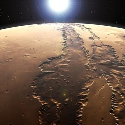 Sunrise over Valles Marineris, a massive canyon on the surface of Mars