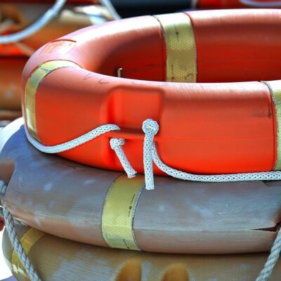 Stacked lifebuoys with ropes wrapped around them