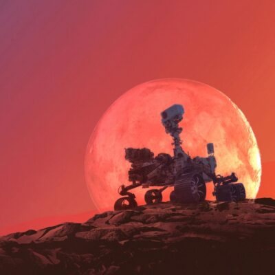 Mars rover on rocky terrain with large red planet in background