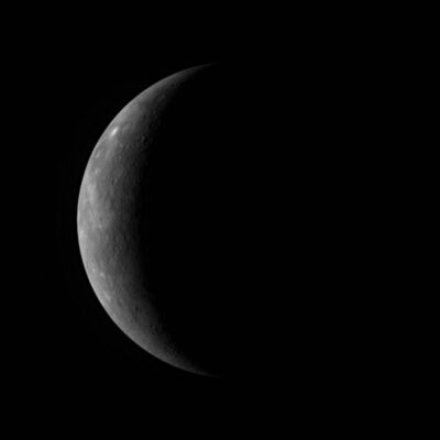Crescent view of Mercury's cratered surface against black space