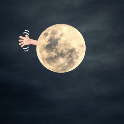 The Moon with a cartoon hand waving from its side against a dark sky