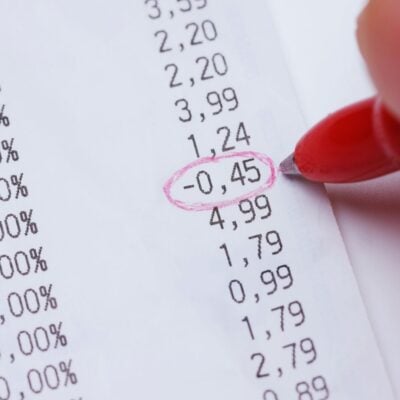 Red pen circling a negative number on a printed receipt
