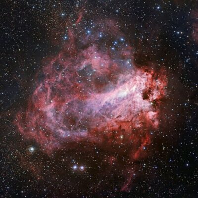 Brightly colored Omega Nebula with glowing gas and dense star field