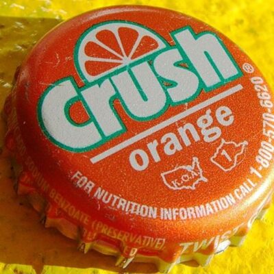 Close-up of an Orange Crush soda bottle cap with logo and text