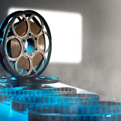 Close-up of a vintage film reel unwinding on a flat surface